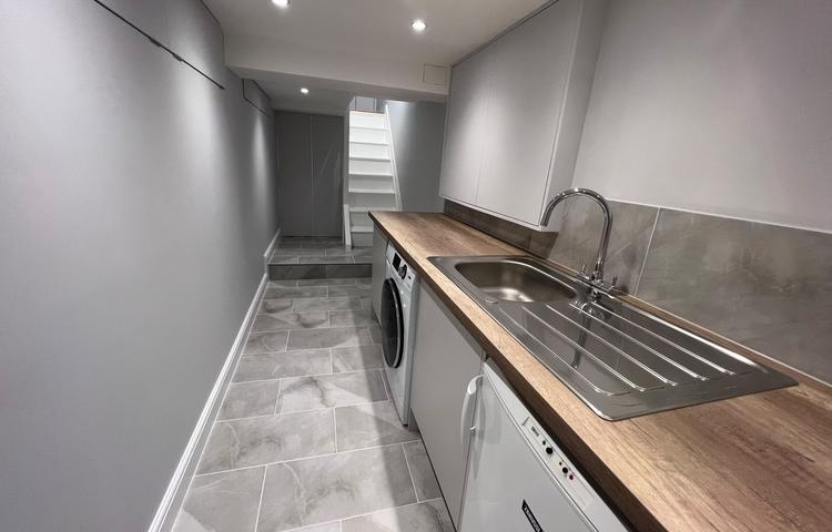 Completed converted cellar interior with fitted cupboards in Clapham