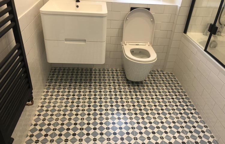 Bathroom with patterned floor tiles and new sanitaryware in Lewisham