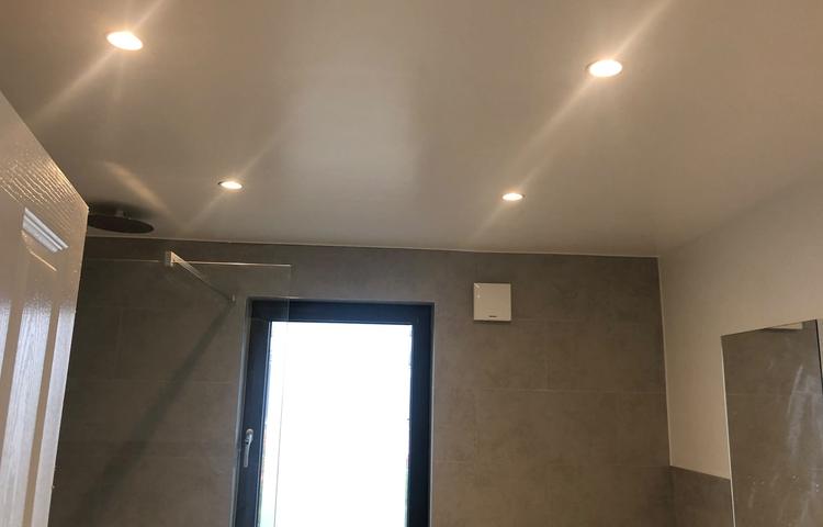 Grey tiled bathroom with recessed lighting in Lewisham