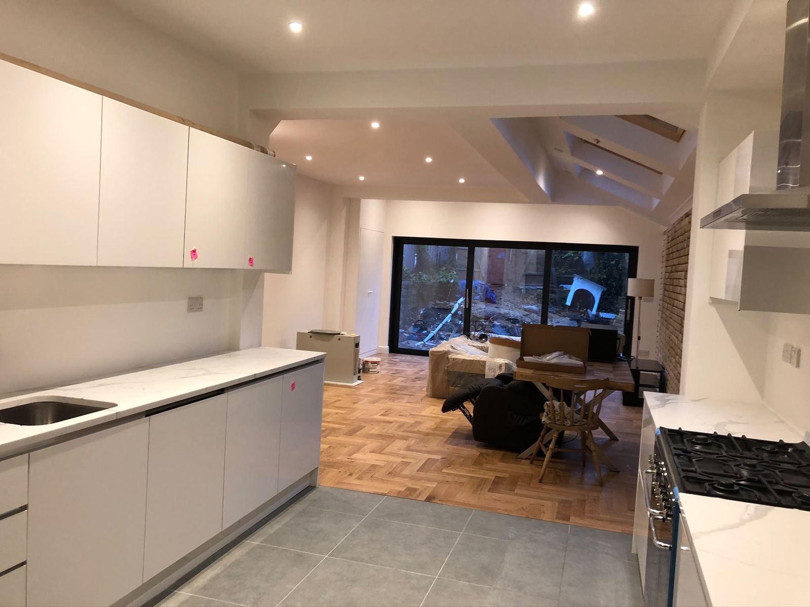 Open-plan kitchen and living space with parquet flooring in a Lewisham side-return extension
