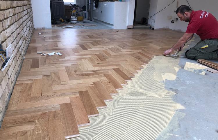 New parquet wood flooring being installed in Lewisham