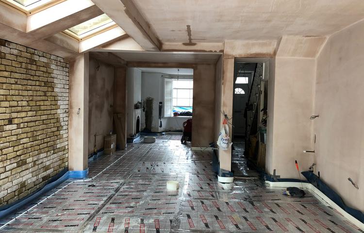 Underfloor heating being fitted in the open-plan space in Lewisham