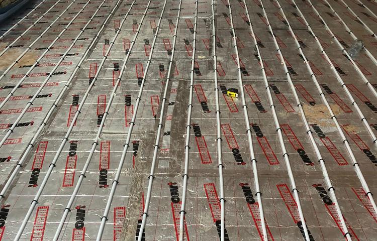 Underfloor heating installation viewed along the room in Lewisham